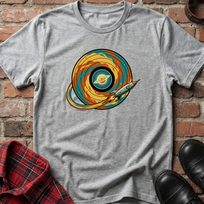 Gray t-shirt with a colorful space-themed design on a brick wall background. Minimalist music apparel by pemuyo.