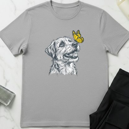 Gray t-shirt with a dog and butterfly graphic on a marble surface. Minimalist dog apparel by pemuyo.