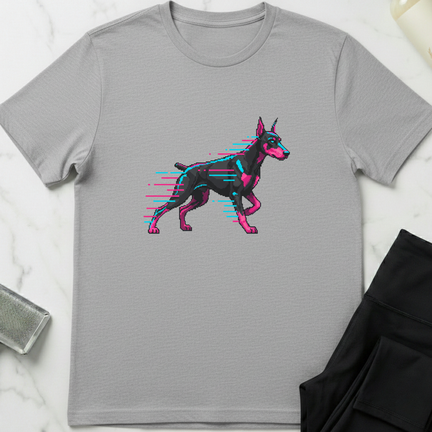 Gray t-shirt with a graphic of a pink and black dog on a marble surface. Minimalist dog apparel by pemuyo.