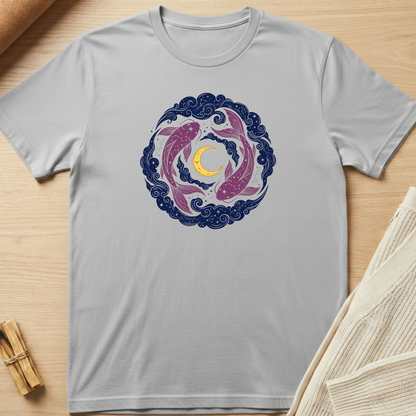 Gray t-shirt with a colorful design of two fish circling a moon on a wooden surface. Minimalist yoga apparel by pemuyo.