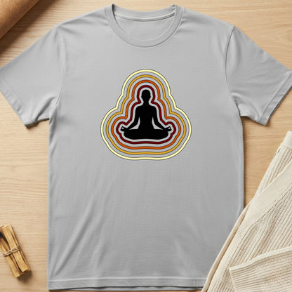 Gray t-shirt with a meditating figure design on a wooden surface. Minimalist yoga apparel by pemuyo.