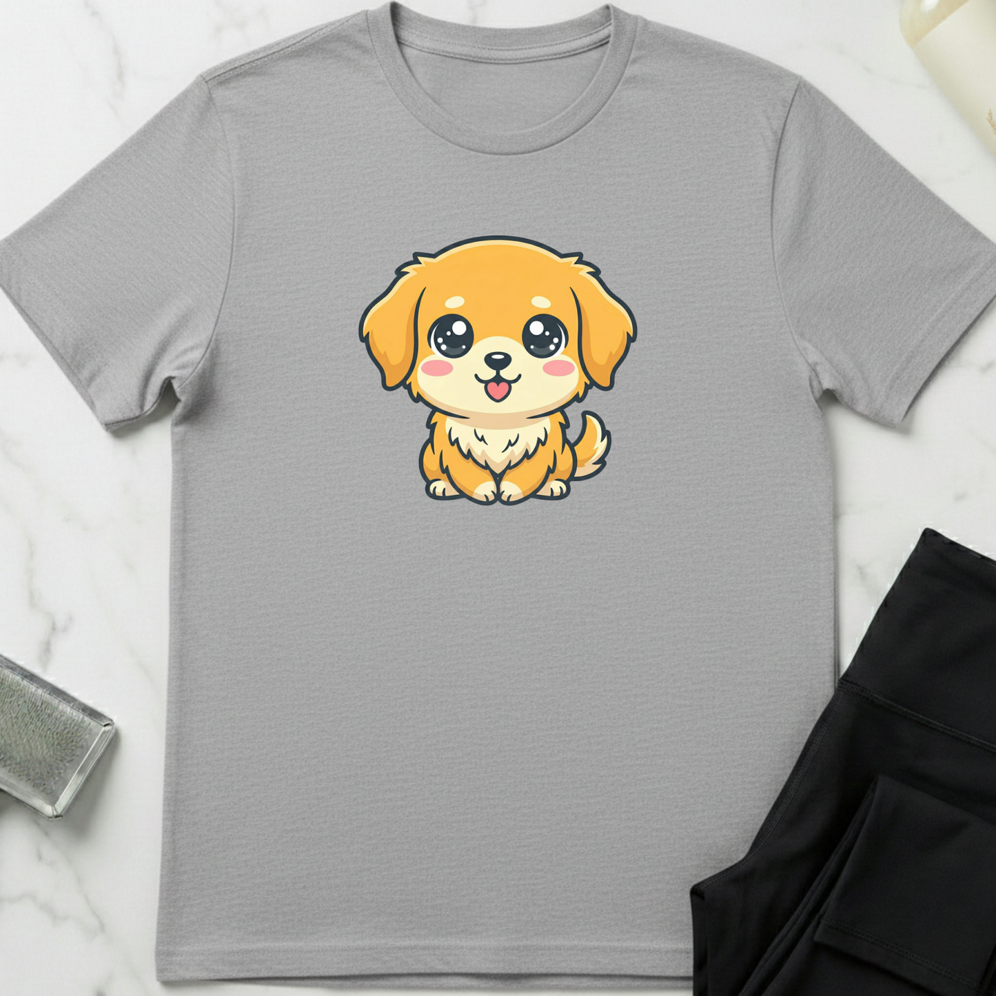 Gray t-shirt with a cartoon dog design on a white marble surface. Minimalist dog apparel by pemuyo.