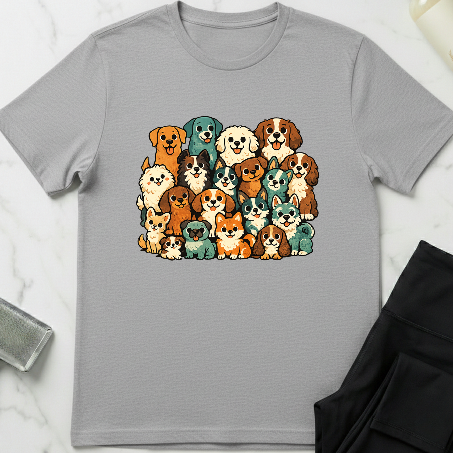 Gray t-shirt with colorful dog illustrations on a white marble surface. Minimalist dog apparel by pemuyo.