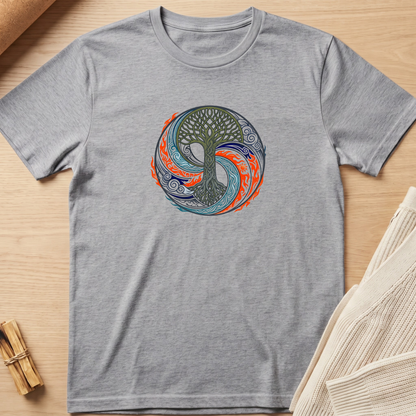 A heather gray short-sleeve t-shirt with a circular graphic of a tree of life in a yin-yang style, featuring green, blue, and orange elements, laid flat on a light wood background. Minimalist yoga apparel by pemuyo.