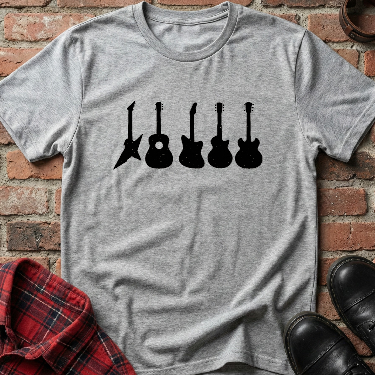 Gray t-shirt with black guitar silhouettes on a brick background. Minimalist music apparel by pemuyo.