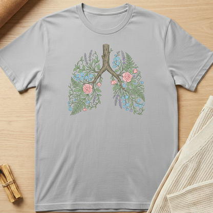 Gray t-shirt with floral lung design on a wooden surface. Minimalist yoga apparel by pemuyo.