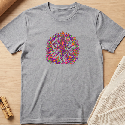 A heather gray short-sleeve t-shirt with a colorful, intricate mandala-style graphic of a dancing figure on the chest, laid flat on a light wood surface with neutral props. Minimalist yoga apparel by pemuyo.