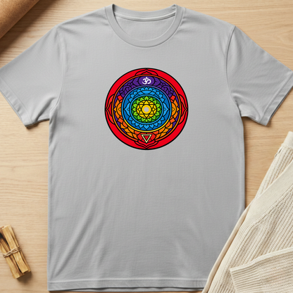 Gray t-shirt with a colorful circular design on a wooden surface. Minimalist yoga apparel by pemuyo.