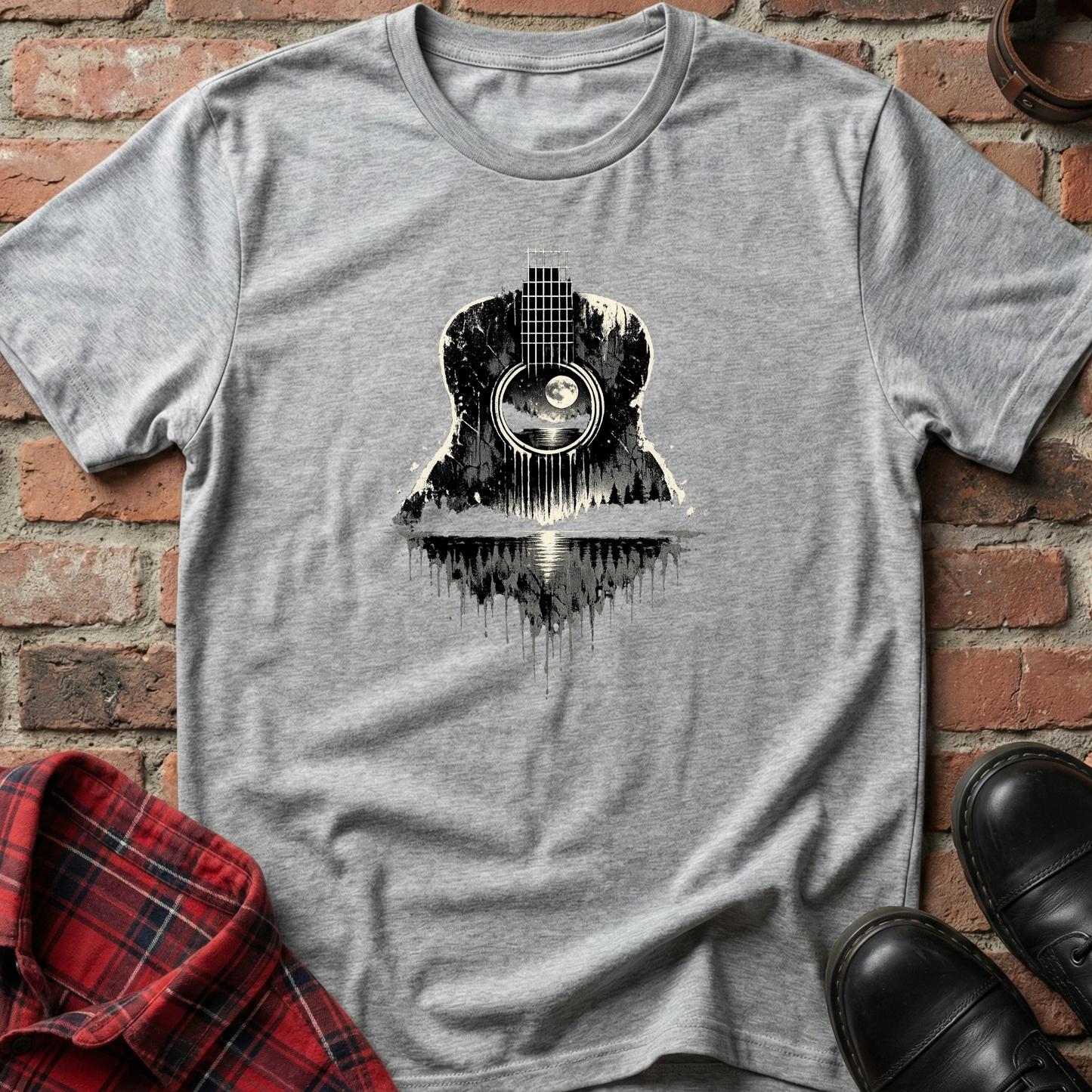 Gray t-shirt with a guitar graphic on a brick background. Minimalist music apparel by pemuyo.