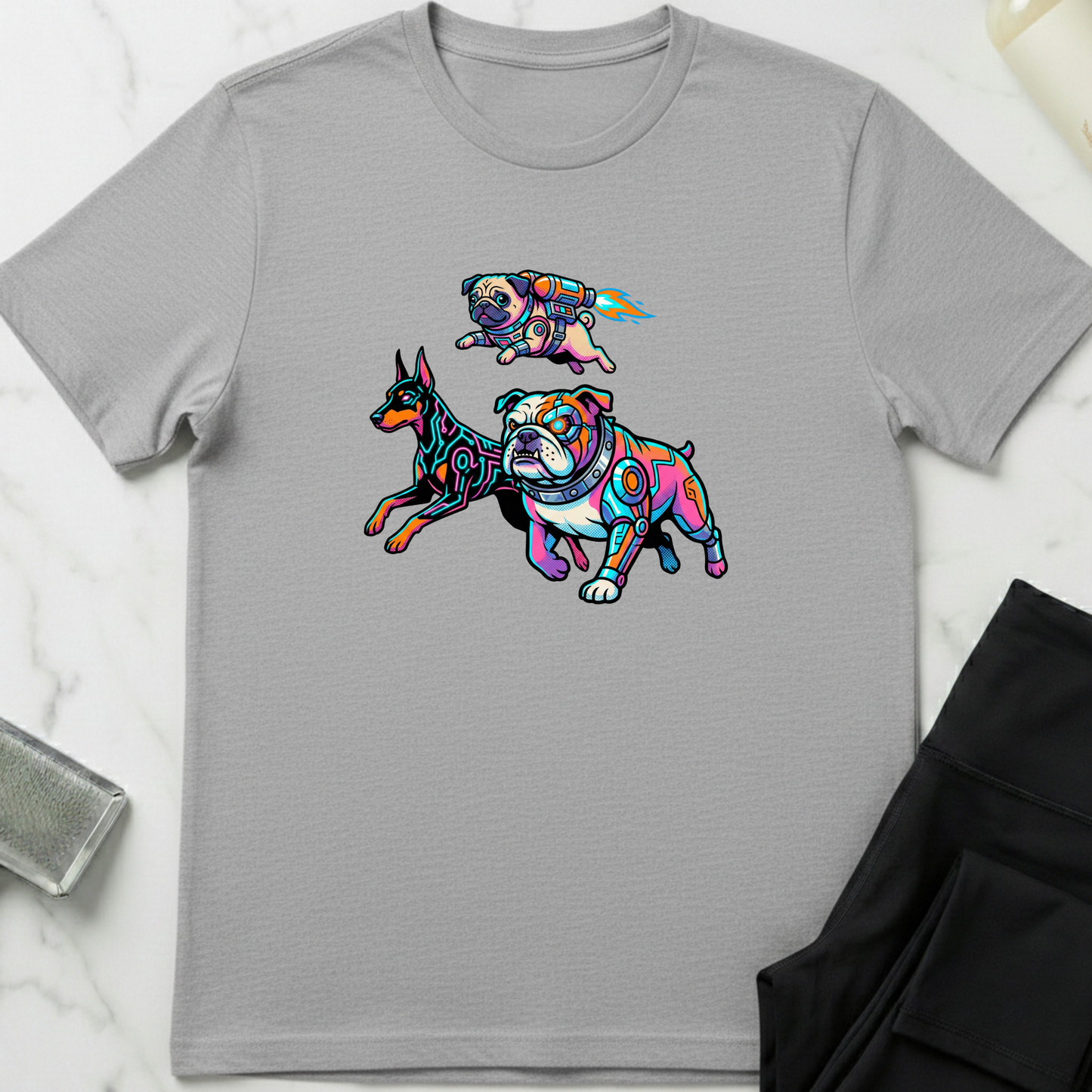 Gray t-shirt with colorful dog illustrations on a white marble surface. Minimalist dog apparel by pemuyo.