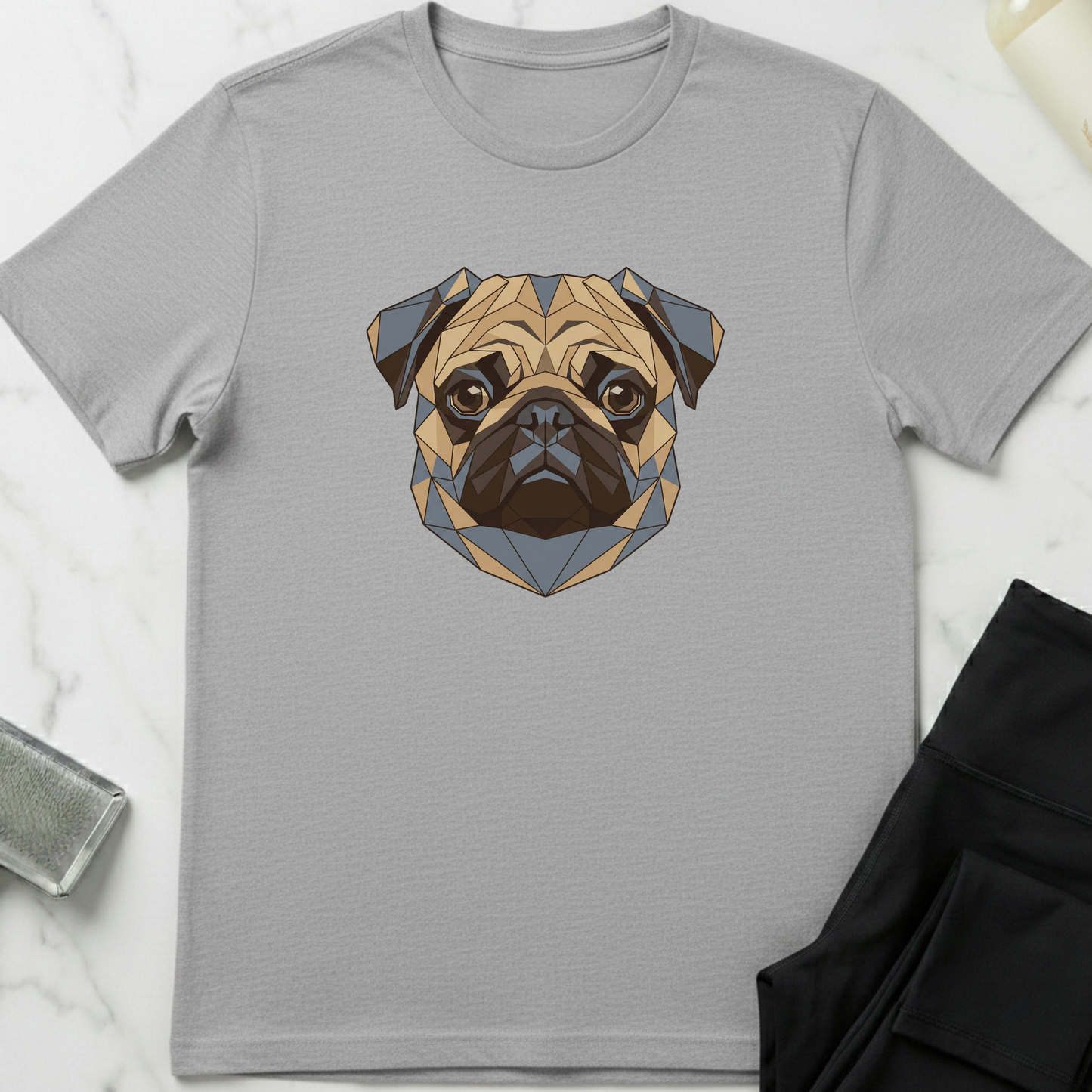 Gray t-shirt with a geometric pug design on a marble surface. Minimalist dog apparel by pemuyo.