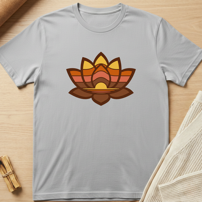 Gray t-shirt with a colorful lotus flower design on a wooden surface. Minimalist yoga apparel by pemuyo.