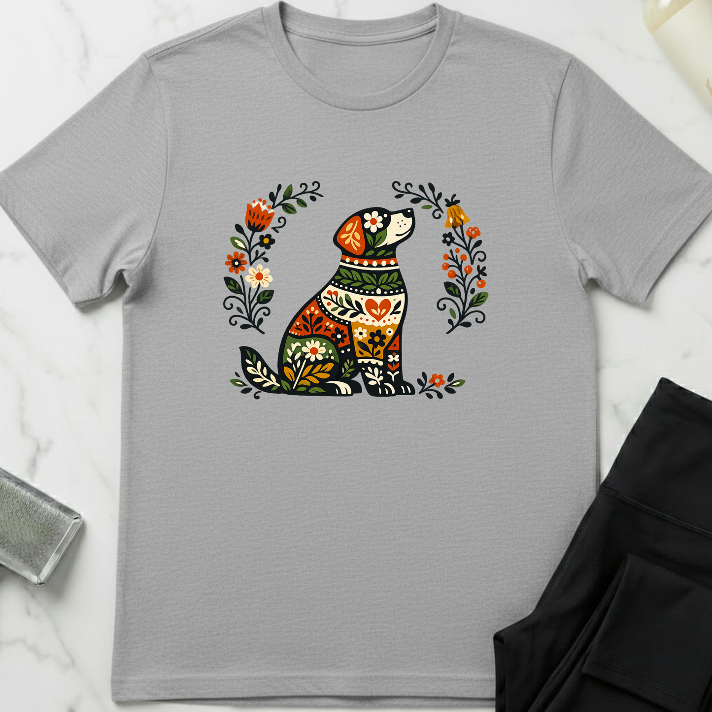 Gray t-shirt with a colorful dog illustration on a white marble surface. Minimalist dog apparel by pemuyo.