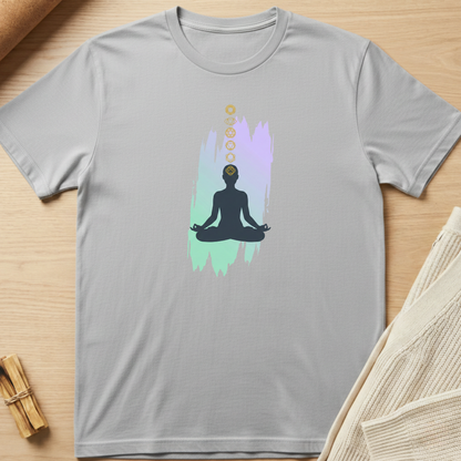 Gray t-shirt with a meditation graphic on a wooden surface. Minimalist yoga apparel by pemuyo.