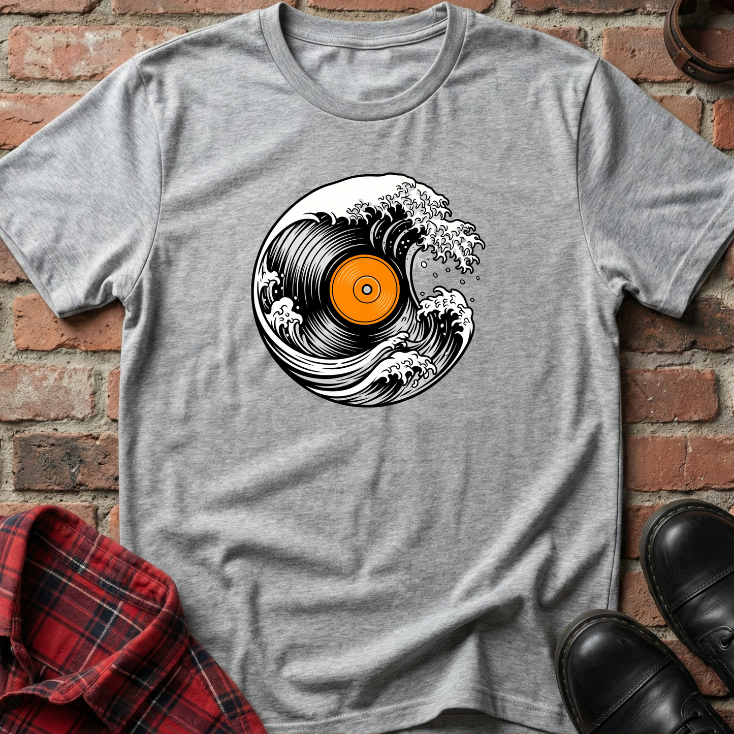 Gray t-shirt with vinyl record design on a brick wall background. Minimalist music apparel by pemuyo.