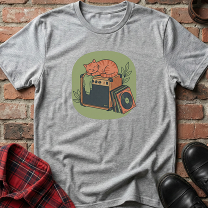 Gray t-shirt with a graphic of a cat on an amplifier against a brick wall. Minimalist music apparel by pemuyo.