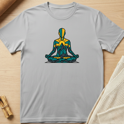 Gray t-shirt with a colorful meditation pose graphic on a wooden surface. Minimalist yoga apparel by pemuyo.