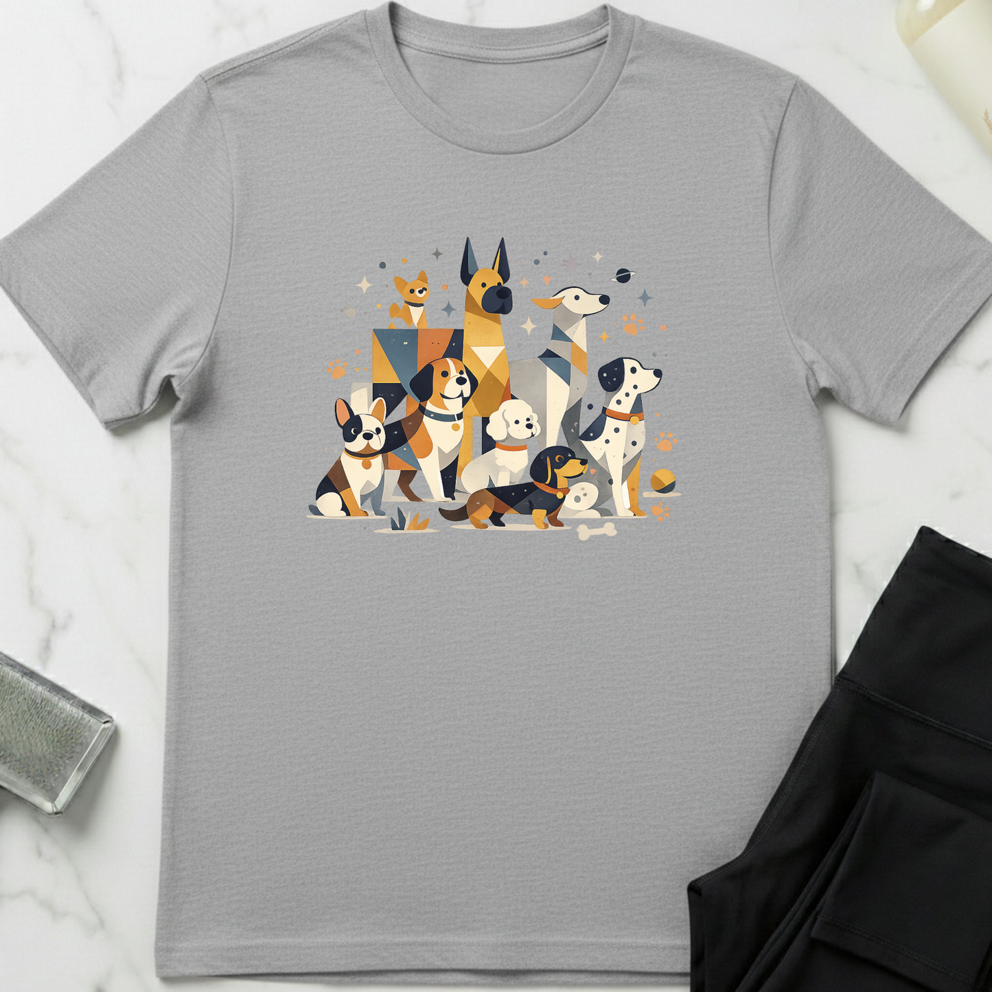 Gray t-shirt with a colorful graphic of dogs on a white marble surface. Minimalist dog apparel by pemuyo.