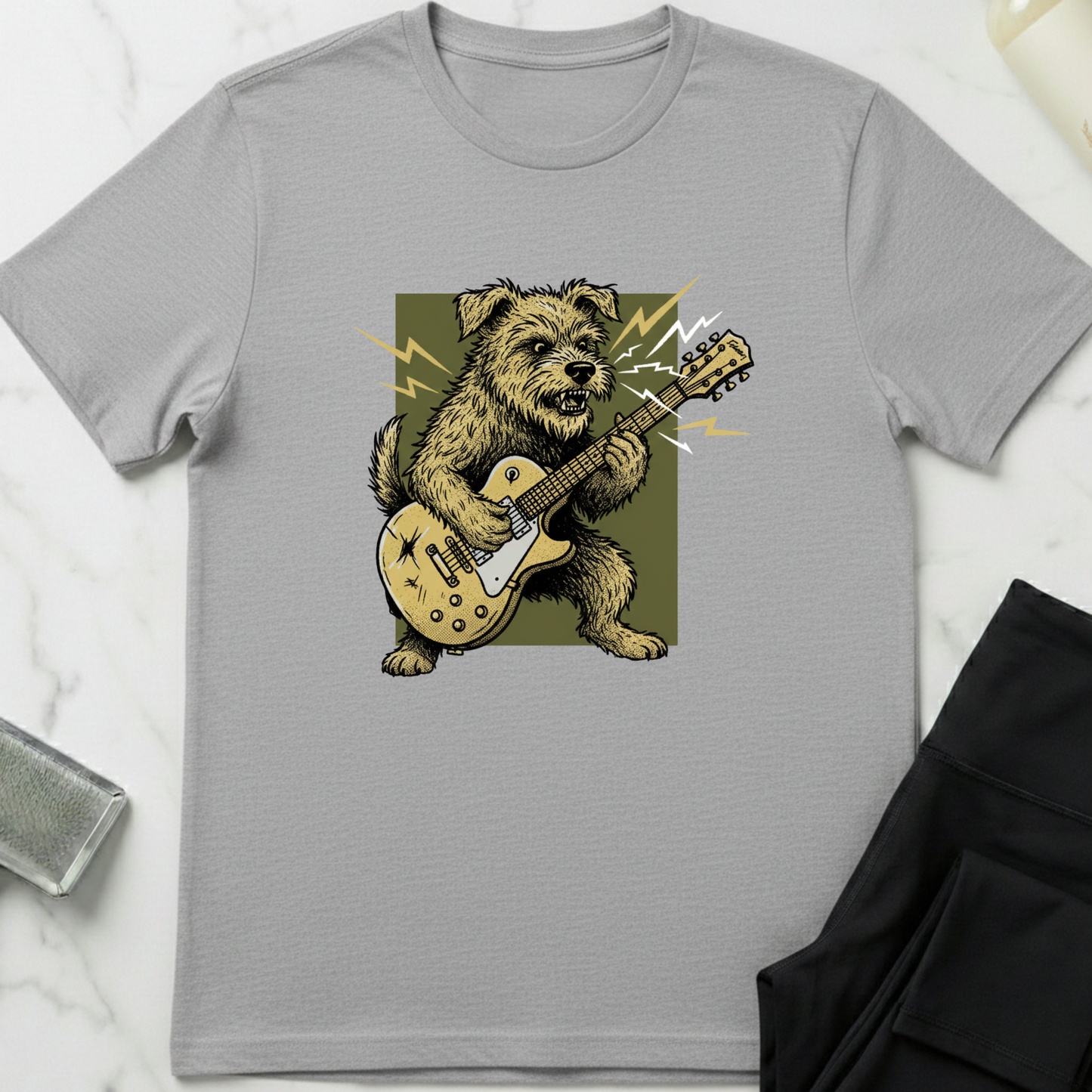 Gray t-shirt with a graphic of a dog playing a guitar on a white marble surface. Minimalist dog apparel by pemuyo.