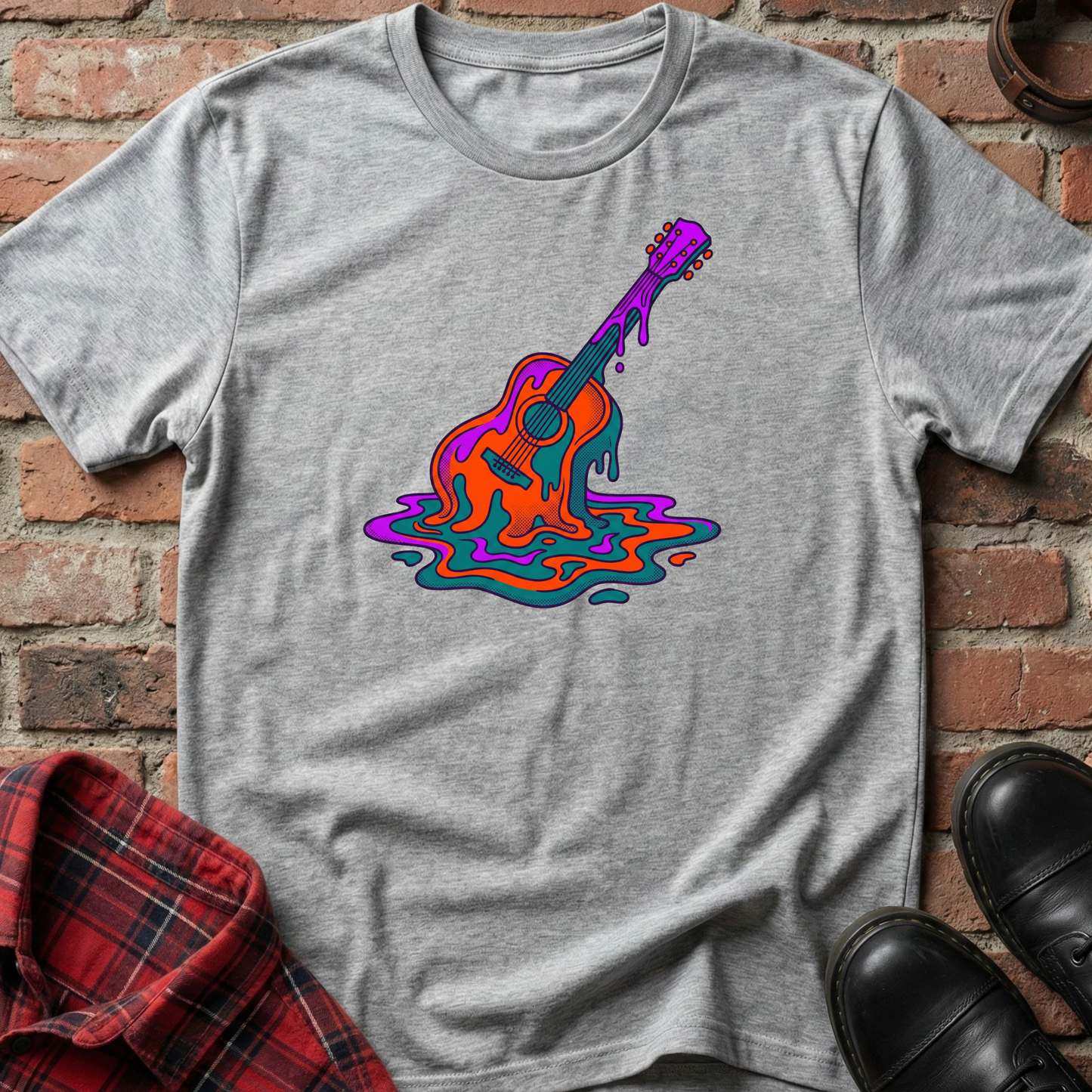 Gray t-shirt with a colorful guitar graphic on a brick wall background. Minimalist music apparel by pemuyo.