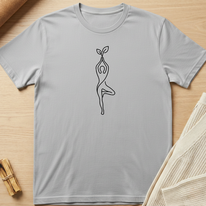 Gray t-shirt with a black line art design of a person holding a plant on a wooden surface. Minimalist yoga apparel by pemuyo.