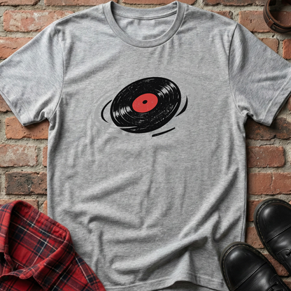 Gray t-shirt with a vinyl record design on a brick surface. Minimalist music apparel by pemuyo.