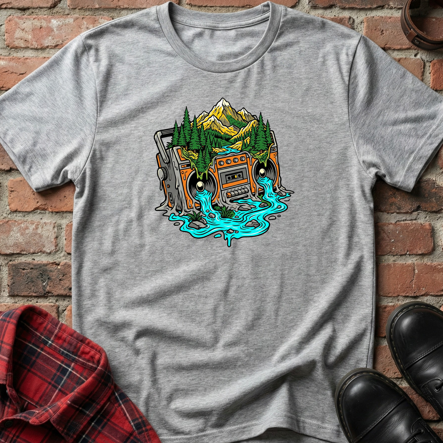 Gray t-shirt with a graphic design of a vintage radio and nature elements on a brick background. Minimalist music apparel by pemuyo.