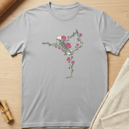 Gray t-shirt with a skeleton and floral design on a wooden surface. Minimalist yoga apparel by pemuyo.