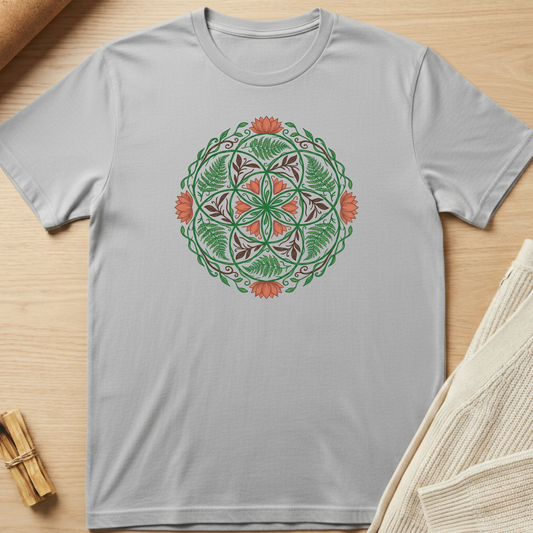 Gray t-shirt with a green and orange mandala design on a wooden surface. Minimalist yoga apparel by pemuyo.