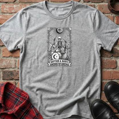 Gray t-shirt with blue drum set design on a brick surface. Minimalist music apparel by pemuyo.