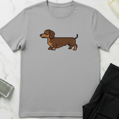 Gray t-shirt with a pixelated dachshund graphic on a marble surface. Minimalist dog apparel by pemuyo.