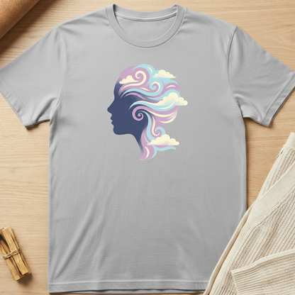 Gray t-shirt with a colorful silhouette design of a woman's head on a wooden surface. Minimalist yoga apparel by pemuyo.