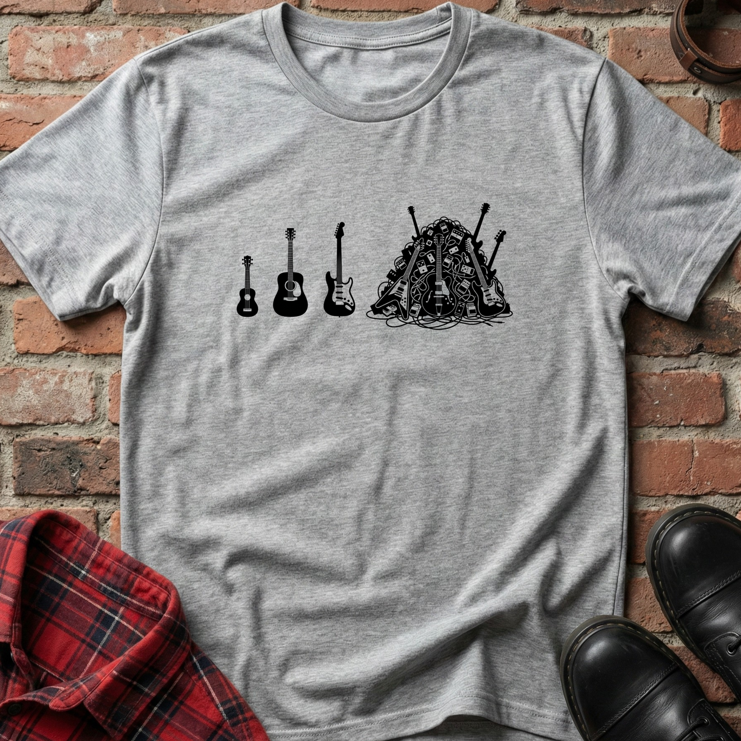 Gray t-shirt with black graphic design of guitars on a brick background. Minimalist music apparel by pemuyo.