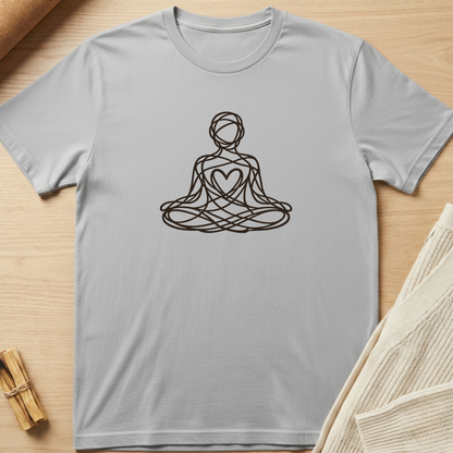 Gray t-shirt with a black line art design of a person in a meditative pose on a wooden surface. Minimalist yoga apparel by pemuyo.