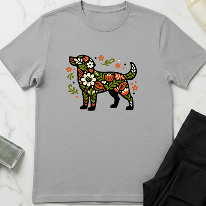 Gray t-shirt with a colorful floral dog design on a marble surface. Minimalist dog apparel by pemuyo.