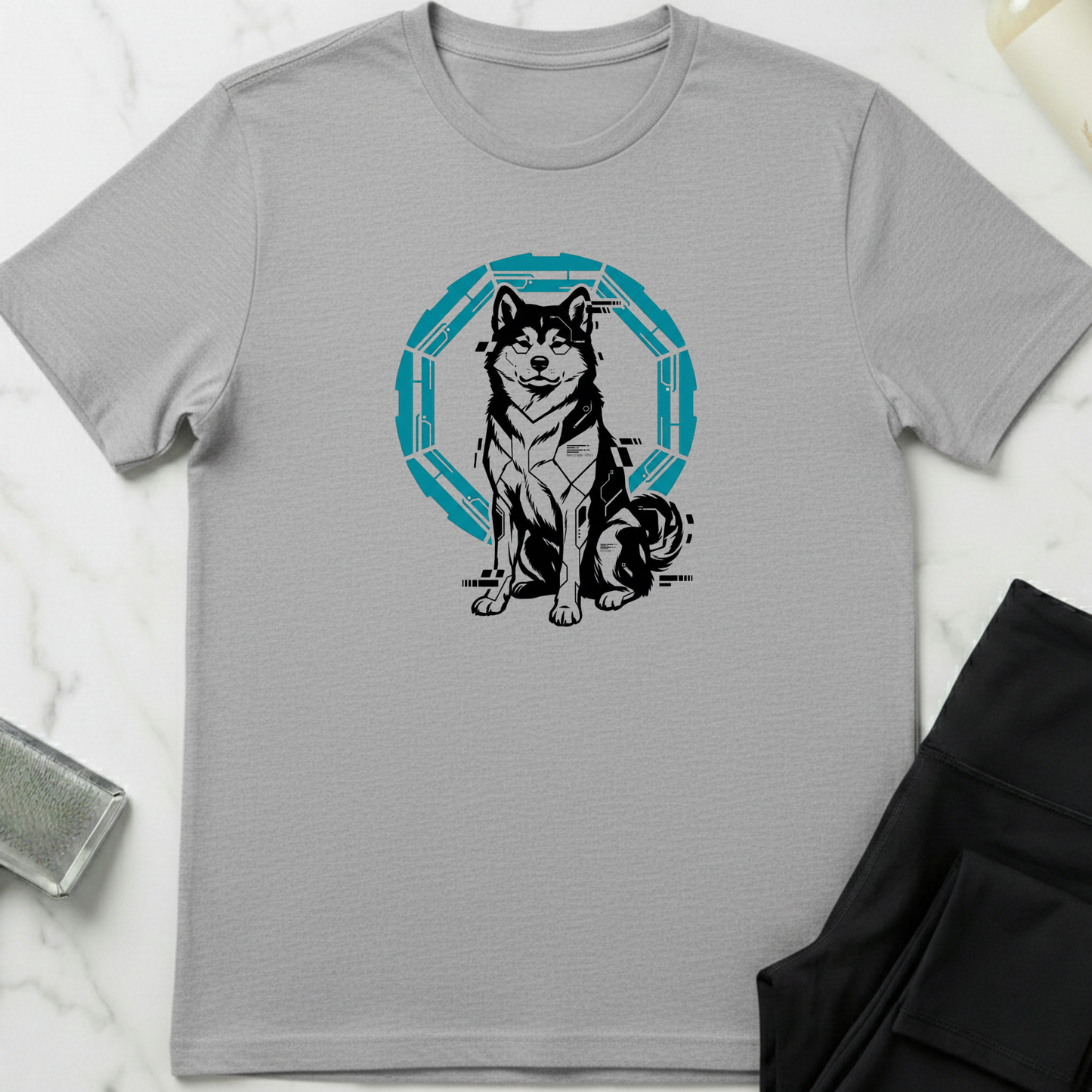 Gray t-shirt with a dog graphic design on a marble surface. Minimalist dog apparel by pemuyo.