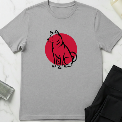 Gray t-shirt with a red circle and black dog illustration on a white marble surface. Minimalist dog apparel by pemuyo.