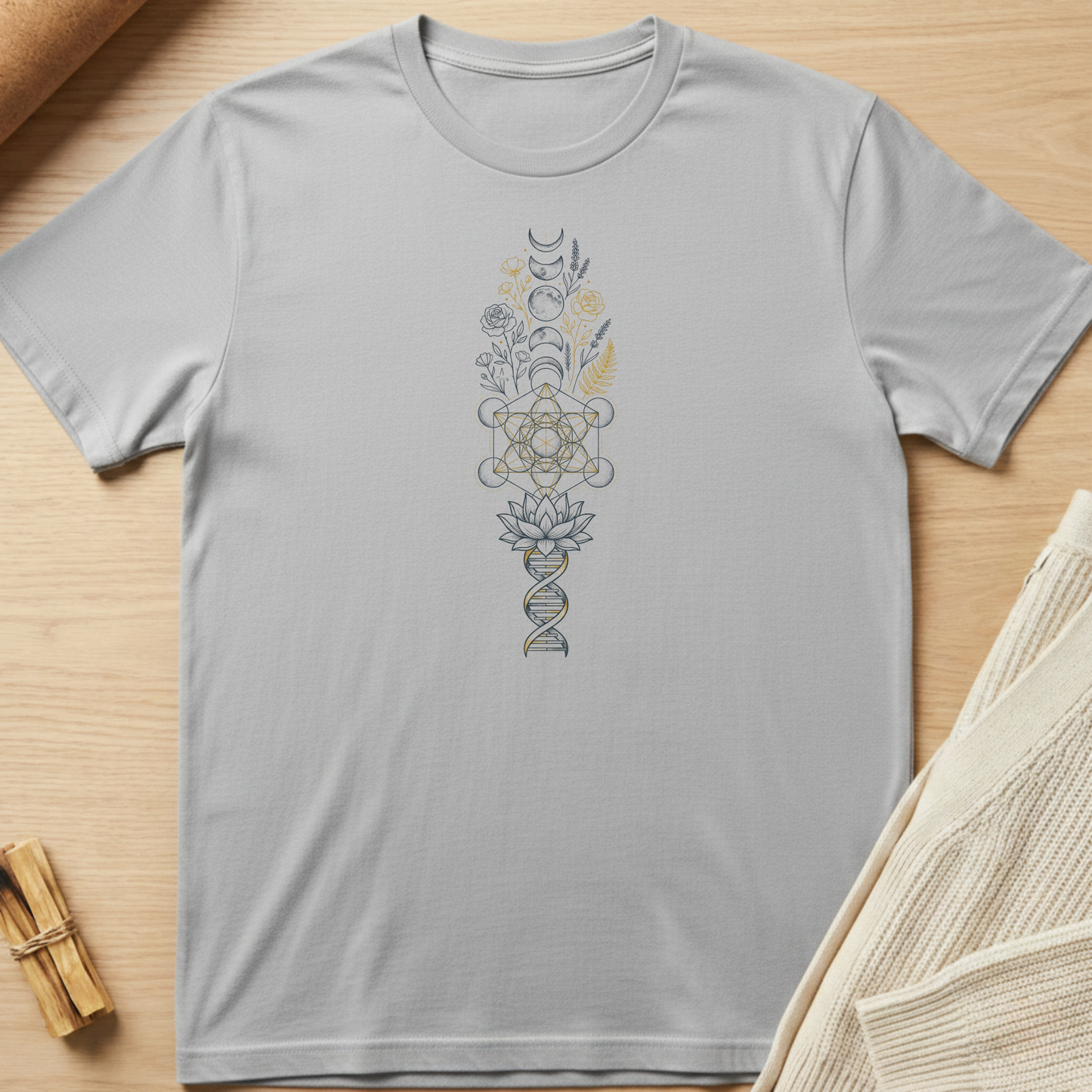 Gray t-shirt with a vertical design on a wooden surface. Minimalist yoga apparel by pemuyo.