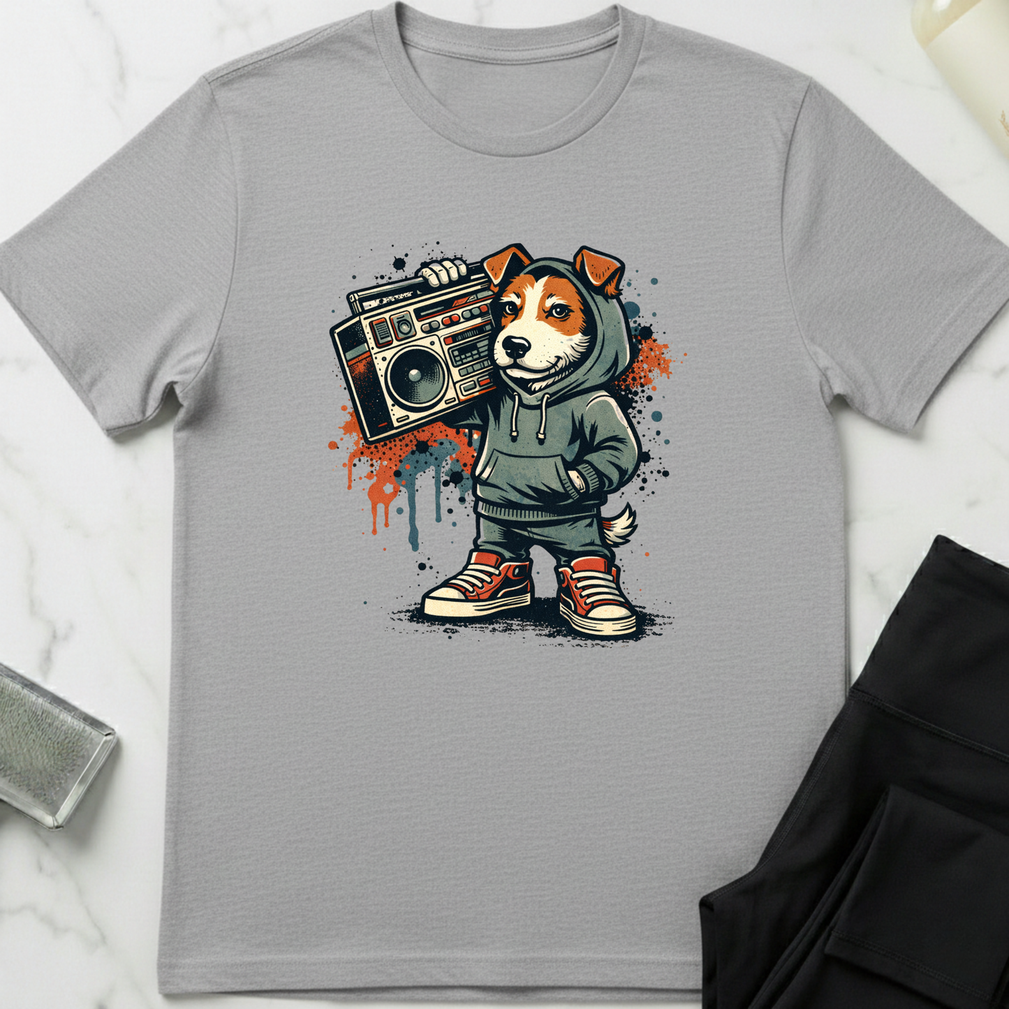 Gray t-shirt with a graphic of a dog in a hoodie holding a boombox on a white background. Minimalist dog apparel by pemuyo.