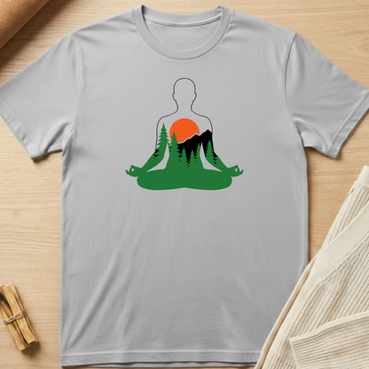 Gray t-shirt with a graphic design of a person meditating in nature on a wooden surface. Minimalist yoga apparel by pemuyo.