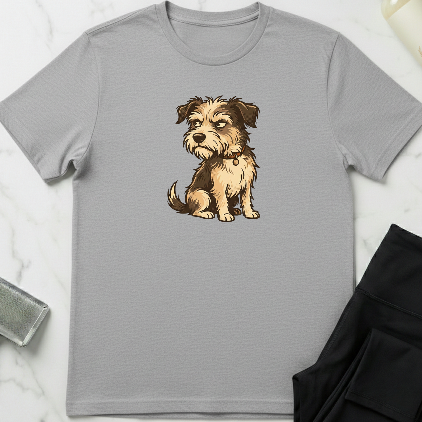 Gray t-shirt with a dog graphic on a white marble surface. Minimalist dog apparel by pemuyo.