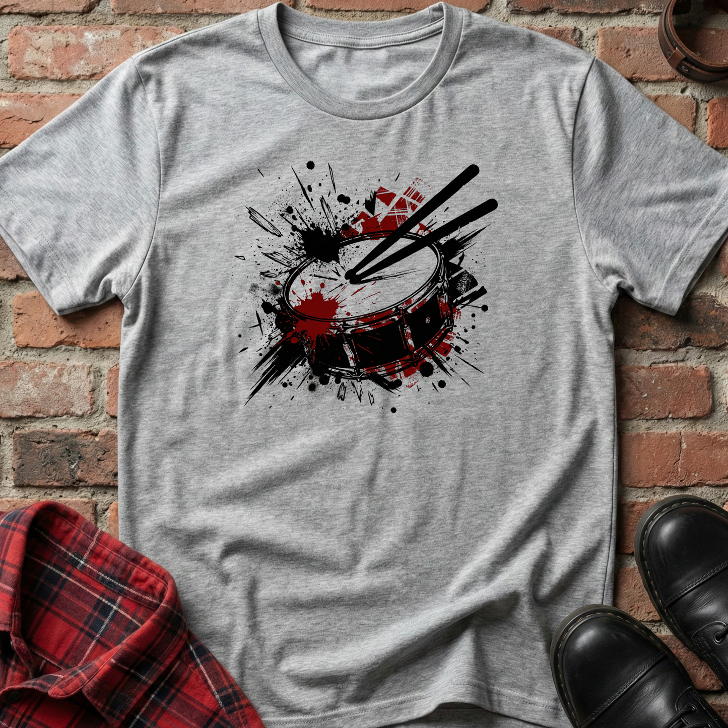 Gray t-shirt with a drum design on a brick background. Minimalist music apparel by pemuyo.