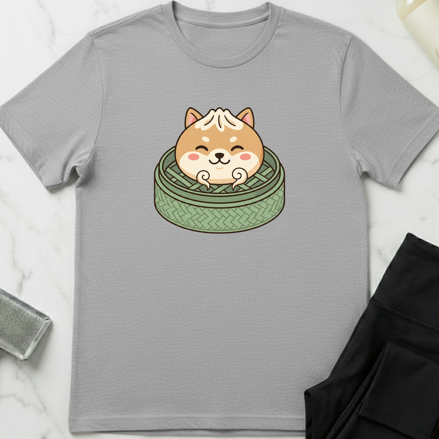 Gray t-shirt with a cute dog design on a marble surface. Minimalist dog apparel by pemuyo.