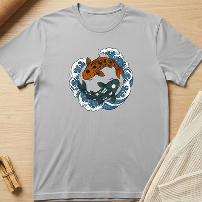 Gray t-shirt with koi fish design on a wooden surface. Minimalist yoga apparel by pemuyo.
