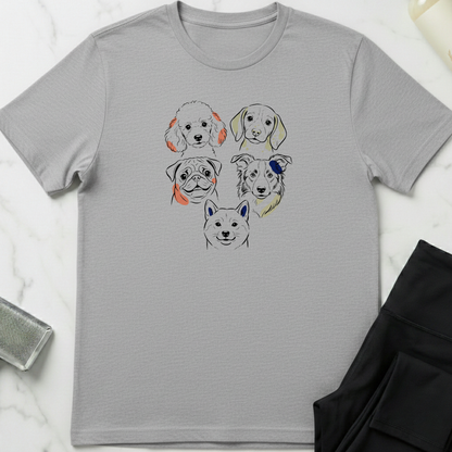 Gray t-shirt with dog illustrations on a white marble surface. Minimalist dog apparel by pemuyo.