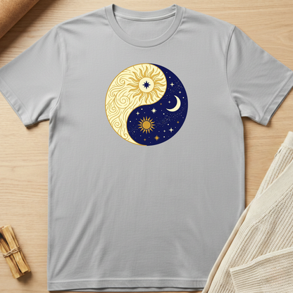 Gray t-shirt with a yin yang design featuring celestial elements on a wooden surface. Minimalist yoga apparel by pemuyo.