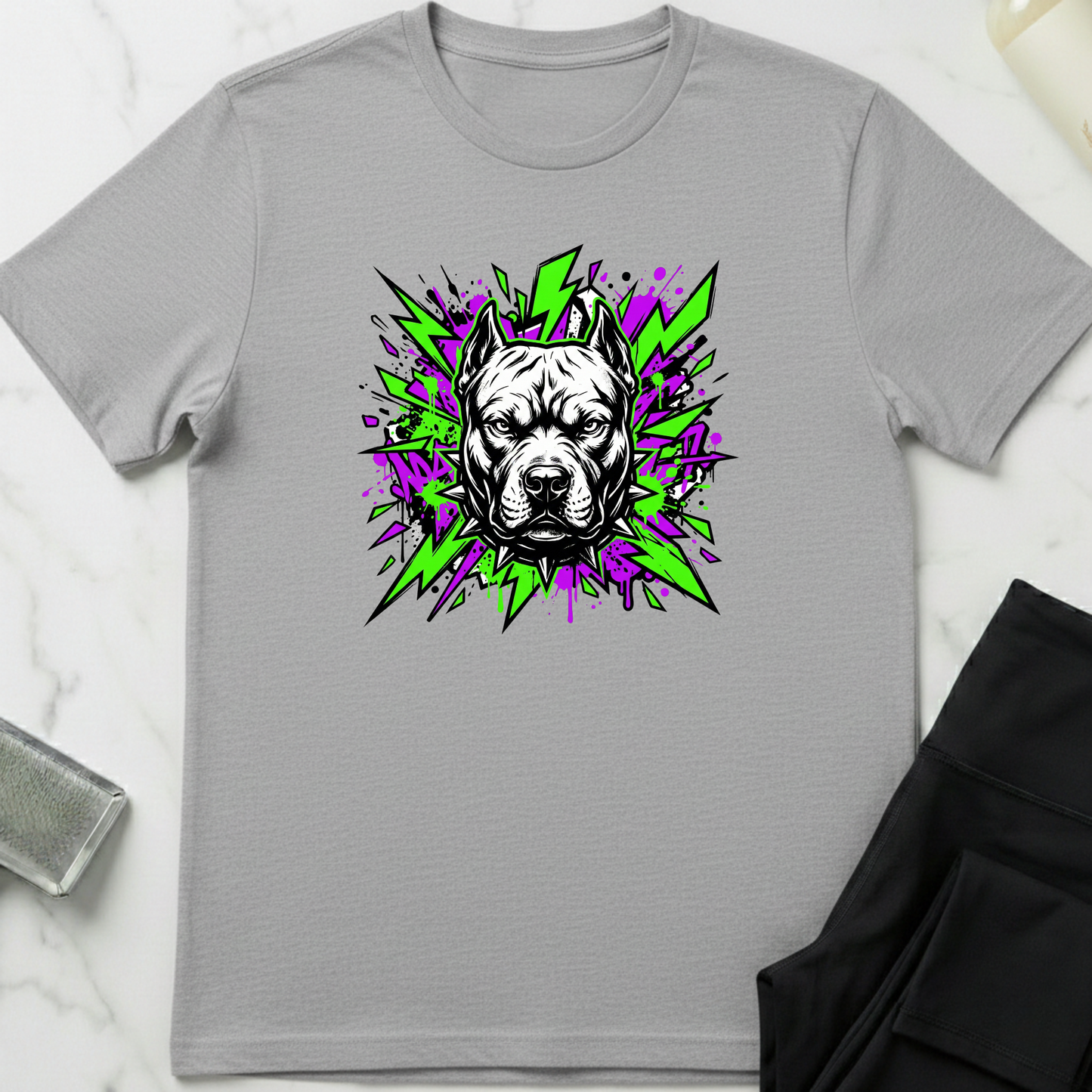 Gray t-shirt with a graphic of a dog's face on a white marble surface. Minimalist dog apparel by pemuyo.