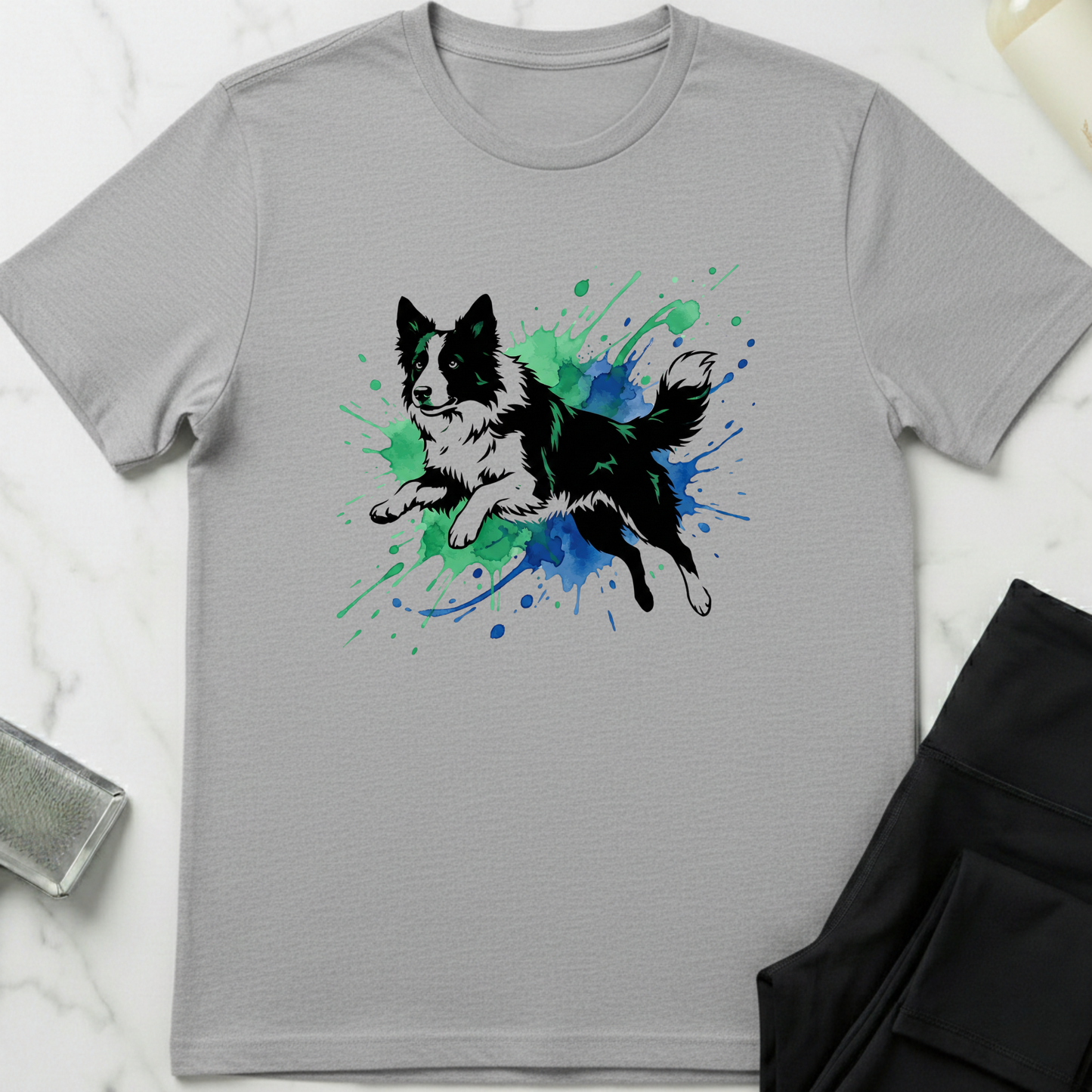 Gray t-shirt with a dog graphic on a white surface. Minimalist dog apparel by pemuyo.