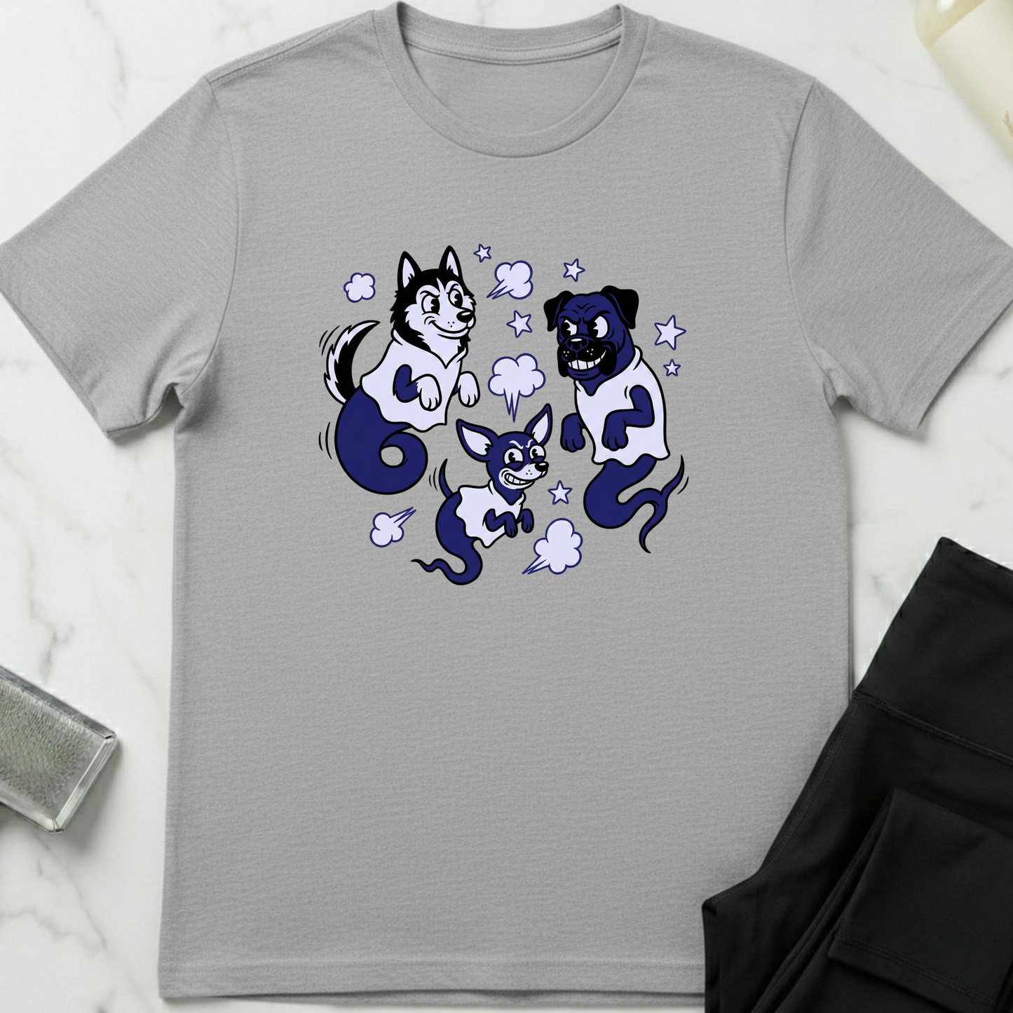 Gray t-shirt with cartoon dog design on a white surface. Minimalist dog apparel by pemuyo.