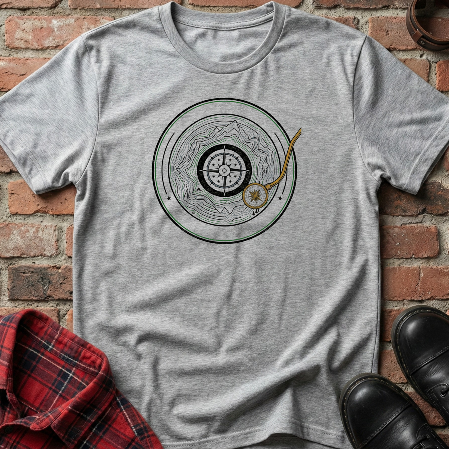 Gray t-shirt with a circular design featuring a mountain vinyl on a brick background. Minimalist music apparel by pemuyo.
